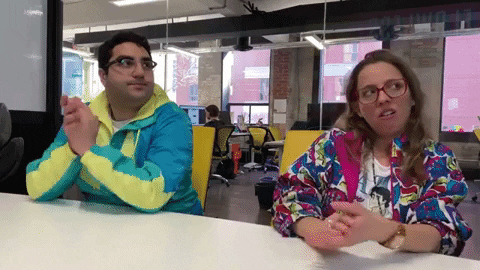 Man and woman clapping, bored at meeting